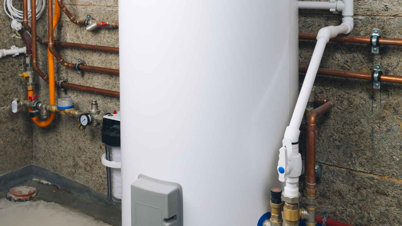 Boiler installation with copper pipework and a white condensate pipe Underfloor heating manifold with circulation pump, control valves and connected pipework.