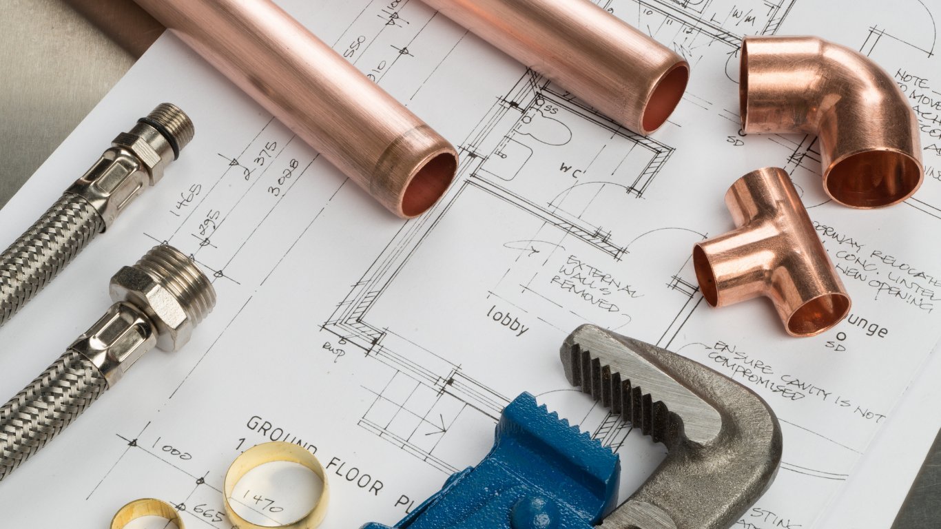 Hot water cylinder with copper pipework, expansion vessel and heating controls. Underfloor heating manifold with circulation pump, control valves and connected pipework.